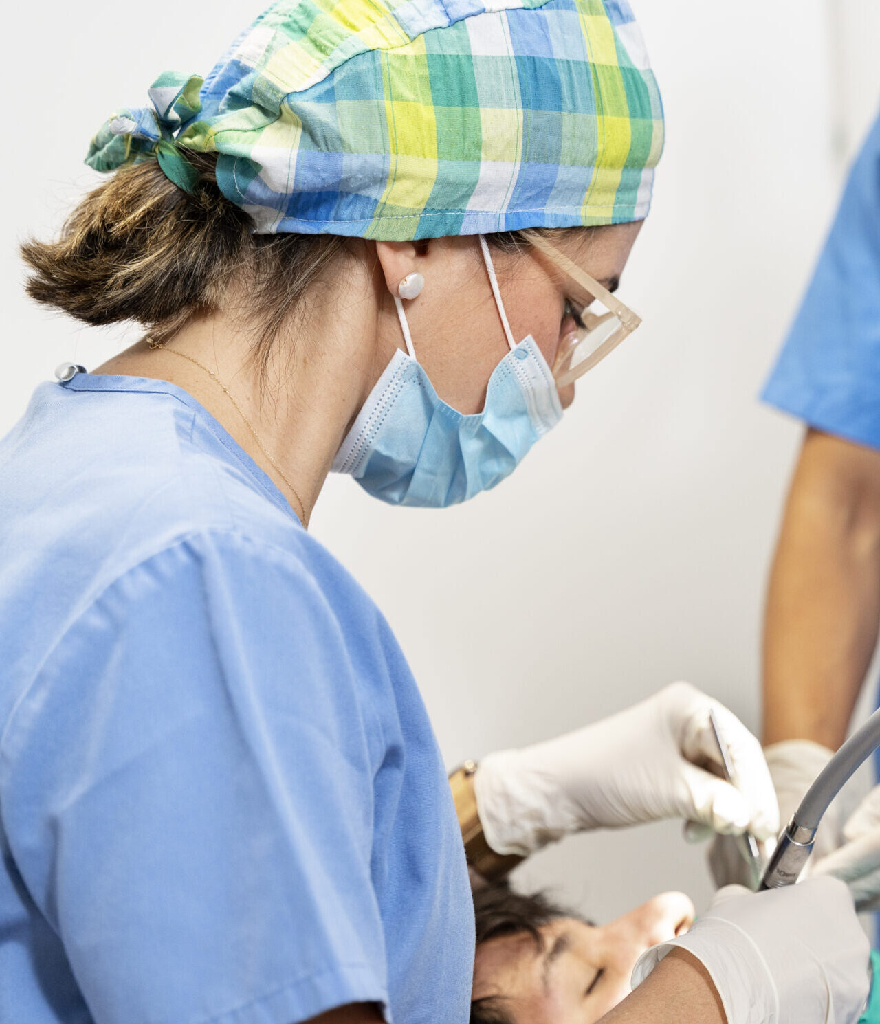 dentist performing dental procedure on patient in clinic