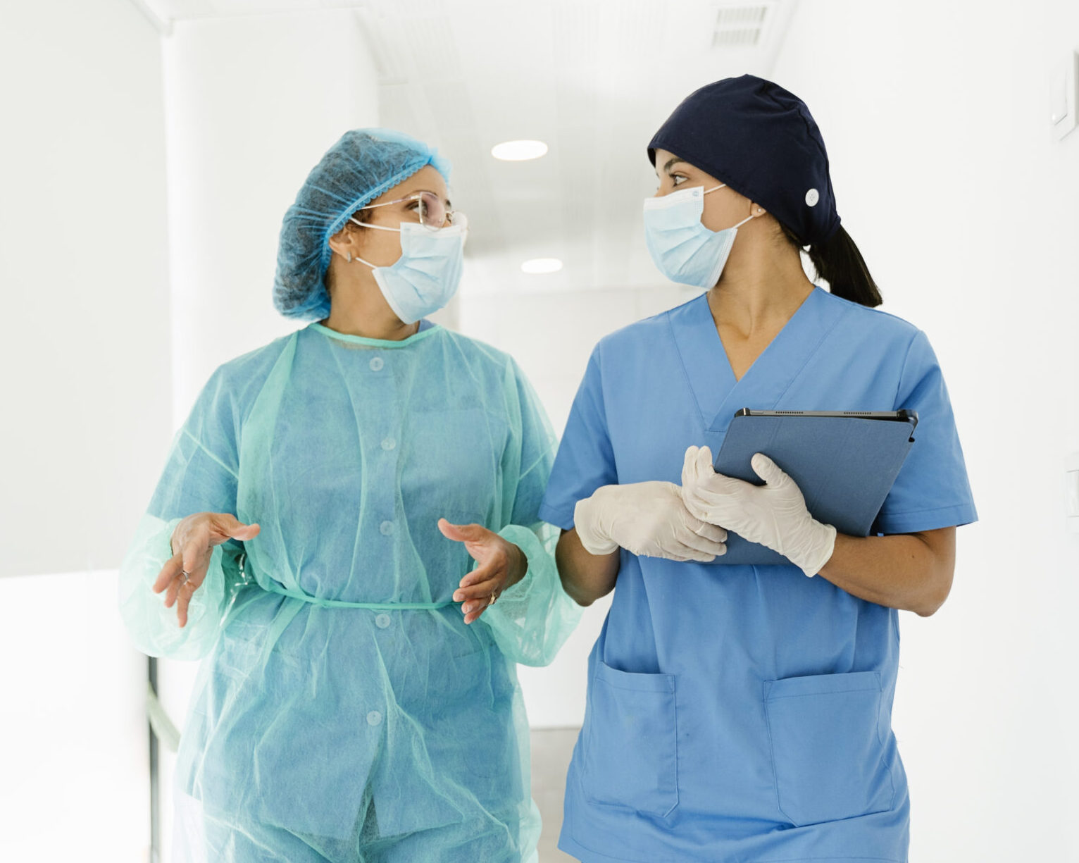 medical staff walking and talking in hospital corridor