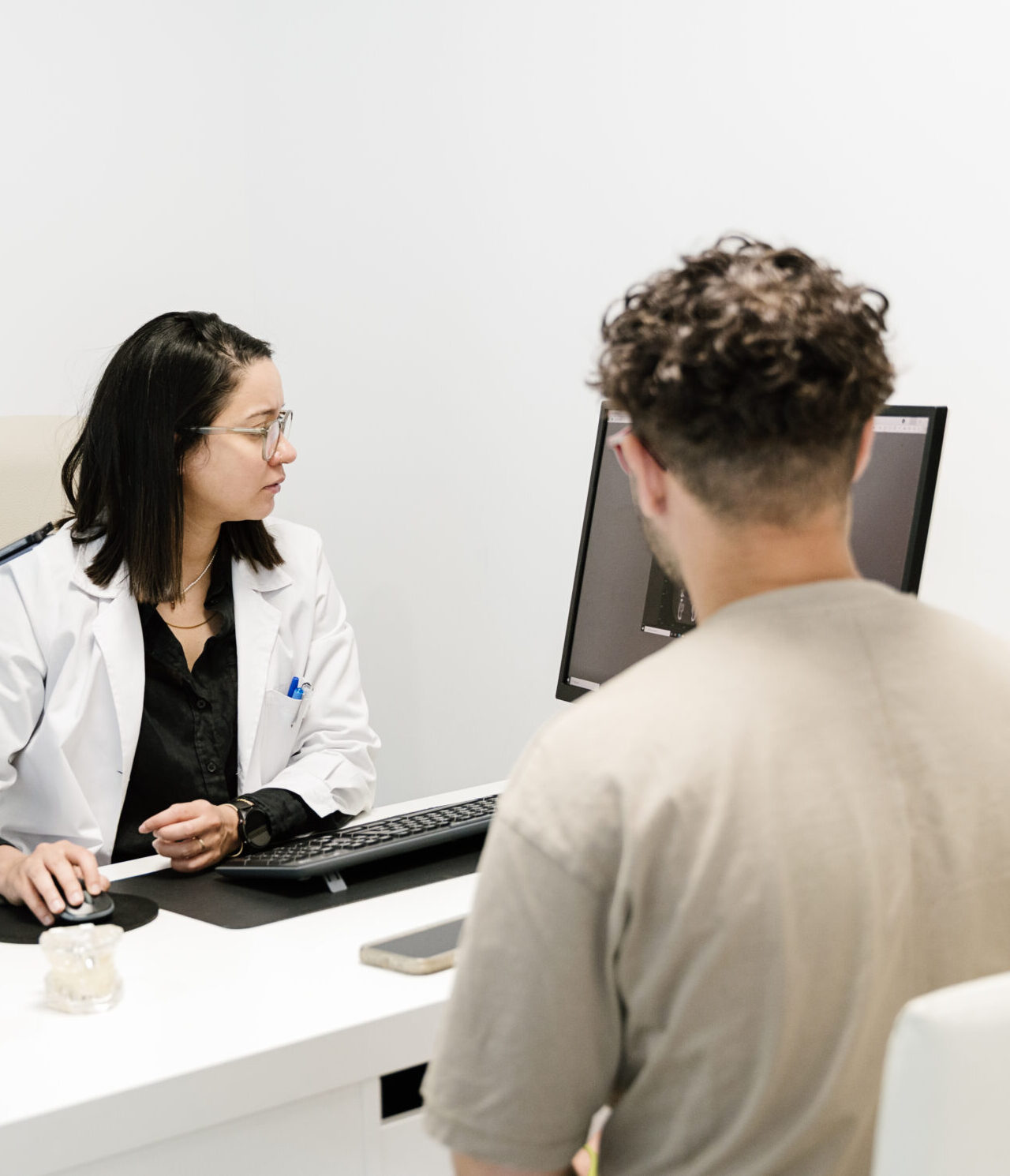 dentist showing x ray to patient in dental clinic